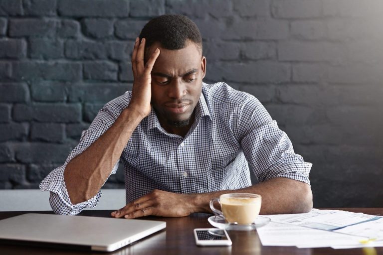 unhappy african businessman feeling stressed frustrated