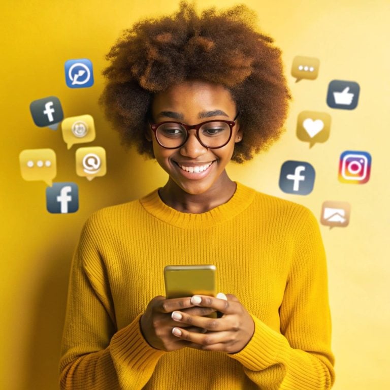 woman with yellow sweater is holding phone with facebook social media icons